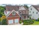 Charming two-story brick home with a covered porch, landscaped yard, and two-car garage at 5280 Lakerock Way, South Fulton, GA 30331