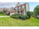 Grassy front yard view of a lovely brick home with a front porch and attached two car garage at 5280 Lakerock Way, South Fulton, GA 30331