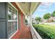 Inviting covered front porch with brick facade and a view of the well-maintained neighborhood street at 5280 Lakerock Way, South Fulton, GA 30331