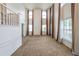 Bright living room with soaring ceilings, tall windows, stylish curtains, and staircase at 5280 Lakerock Way, South Fulton, GA 30331