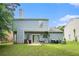 Spacious backyard with grass, a patio with grill, and a two-story home exterior at 6279 Marbut Farms Rd, Lithonia, GA 30058