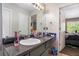 Vanity in bathroom with ample counter space, a large mirror, and views into the main bedroom at 6279 Marbut Farms Rd, Lithonia, GA 30058