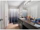 Bathroom featuring a shower-tub combo, large vanity with ample storage, and tiled flooring at 6279 Marbut Farms Rd, Lithonia, GA 30058
