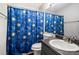 Bathroom with blue celestial shower curtain, white toilet, and granite countertop vanity at 6279 Marbut Farms Rd, Lithonia, GA 30058