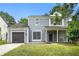 Charming two-story home featuring a well-maintained lawn, attached garage, and inviting front porch at 6279 Marbut Farms Rd, Lithonia, GA 30058