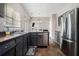 Kitchen featuring gray cabinets, stainless steel dishwasher and refrigerator at 6279 Marbut Farms Rd, Lithonia, GA 30058