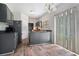 Eat-in kitchen featuring a breakfast bar, wood-look floors, and a sliding glass door at 6279 Marbut Farms Rd, Lithonia, GA 30058