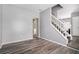 Open living area with a staircase, a neutral color palette, and wood-look flooring at 6279 Marbut Farms Rd, Lithonia, GA 30058