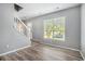 Bright living area with staircase, large window with wood-look floors at 6279 Marbut Farms Rd, Lithonia, GA 30058