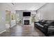 Bright living room with a fireplace, large windows, and comfortable seating on wood-look floors at 6279 Marbut Farms Rd, Lithonia, GA 30058