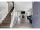 Open living room with a staircase, a fireplace, and durable wood-look flooring at 6279 Marbut Farms Rd, Lithonia, GA 30058