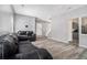 Open living room features dark sofas and durable wood-look flooring at 6279 Marbut Farms Rd, Lithonia, GA 30058