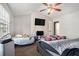 Main bedroom with a ceiling fan, large windows for natural light, and comfortable carpet flooring at 6279 Marbut Farms Rd, Lithonia, GA 30058