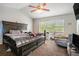 Spacious main bedroom with a ceiling fan, large windows, and carpet flooring at 6279 Marbut Farms Rd, Lithonia, GA 30058