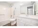 Well-lit bathroom featuring a tub and shower, a large mirror, and a sink with a white vanity at 1800 Clairmont Lk # 412, Decatur, GA 30033