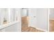 Bright hallway featuring wood-look floors, white trim, and closet with louvered door at 1800 Clairmont Lk # 412, Decatur, GA 30033