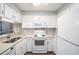 Well-maintained kitchen featuring white cabinets, appliances, and ample counter space at 1800 Clairmont Lk # 412, Decatur, GA 30033