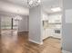 Open-concept living room flows into a kitchen with white cabinets and stainless steel appliances at 1800 Clairmont Lk # 412, Decatur, GA 30033