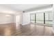 Large living room with wood-look floors, large windows, and chandelier lighting fixture at 1800 Clairmont Lk # 412, Decatur, GA 30033