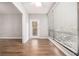 Bright living room with wood floors, large window with blinds, and a glass door leading to the outside at 1800 Clairmont Lk # 412, Decatur, GA 30033
