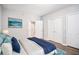 Staged main bedroom features wood-look floors, an ensuite bathroom, and generous closet space at 1800 Clairmont Lk # 412, Decatur, GA 30033