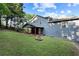 Spacious backyard featuring a fire pit, lush lawn, and partial view of the home's exterior at 2067 Kinridge Ct, Marietta, GA 30062