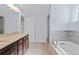 Modern bathroom with a soaking tub, glass shower, and a long vanity with double sinks at 2067 Kinridge Ct, Marietta, GA 30062