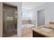 Modern bathroom showcases a glass shower, soaking tub, and elegant granite countertops at 2067 Kinridge Ct, Marietta, GA 30062