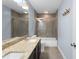 Well-lit bathroom features a granite countertop and a glass-enclosed bathtub with shower at 2067 Kinridge Ct, Marietta, GA 30062