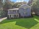 Charming two-story home featuring a lush green lawn and well-maintained landscaping at 2067 Kinridge Ct, Marietta, GA 30062