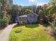 Attractive home with a well-manicured lawn, lush landscaping and a long driveway at 2067 Kinridge Ct, Marietta, GA 30062