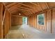 Unfinished space featuring wood framing, a window with natural light, and an open door to the outside at 2067 Kinridge Ct, Marietta, GA 30062