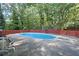 Fenced in in-ground pool with concrete surround at 2067 Kinridge Ct, Marietta, GA 30062