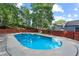 In-ground pool surrounded by a fence, set in the backyard of the home at 2067 Kinridge Ct, Marietta, GA 30062