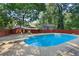 In-ground backyard pool with a concrete surround and backyard view at 2067 Kinridge Ct, Marietta, GA 30062