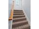 Carpeted stairs with a wood handrail lead to the upper level, illuminated by a window at 2067 Kinridge Ct, Marietta, GA 30062