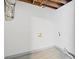 Unfinished basement with white walls and tiled floors at 4760 Silverdale Rd, College Park, GA 30349