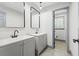 Bathroom featuring gray double vanity sinks and light fixtures at 4760 Silverdale Rd, College Park, GA 30349