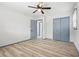 Bright bedroom features wood-look floors, a ceiling fan, closet, and a gray painted door at 4760 Silverdale Rd, College Park, GA 30349