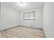 This bedroom features wood-look floors, a window, and white walls at 4760 Silverdale Rd, College Park, GA 30349