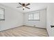 Simple bedroom with natural light, ceiling fan, wood flooring and neutral paint at 4760 Silverdale Rd, College Park, GA 30349