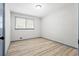 This bedroom has wood-look flooring and a window at 4760 Silverdale Rd, College Park, GA 30349