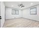 Bedroom with two windows, a ceiling fan, and wood-look flooring at 4760 Silverdale Rd, College Park, GA 30349