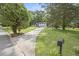 Wide shot of a well-manicured front lawn leading to a charming two-story home at 4760 Silverdale Rd, College Park, GA 30349