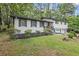 Beautiful home with a combination of white painted brick, siding, and a well-manicured lawn at 4760 Silverdale Rd, College Park, GA 30349