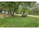 Lush front lawn and mature trees provide a serene setting for this home at 4760 Silverdale Rd, College Park, GA 30349