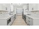 Modern kitchen with white cabinets, marble backsplash, gray lower cabinets and stainless steel appliances at 4760 Silverdale Rd, College Park, GA 30349