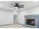 Cozy living room features a ceiling fan, fireplace, and wood flooring at 4760 Silverdale Rd, College Park, GA 30349