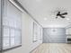 Bright living room featuring new floors, custom wall decor and modern ceiling fan at 4760 Silverdale Rd, College Park, GA 30349