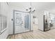 Open living area with stainless appliances, glass panel doors and contemporary lighting at 4760 Silverdale Rd, College Park, GA 30349